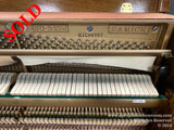 Interior of a Samick SU-243M upright piano showing the tuning pins, strings, and hammers above the keyboard.