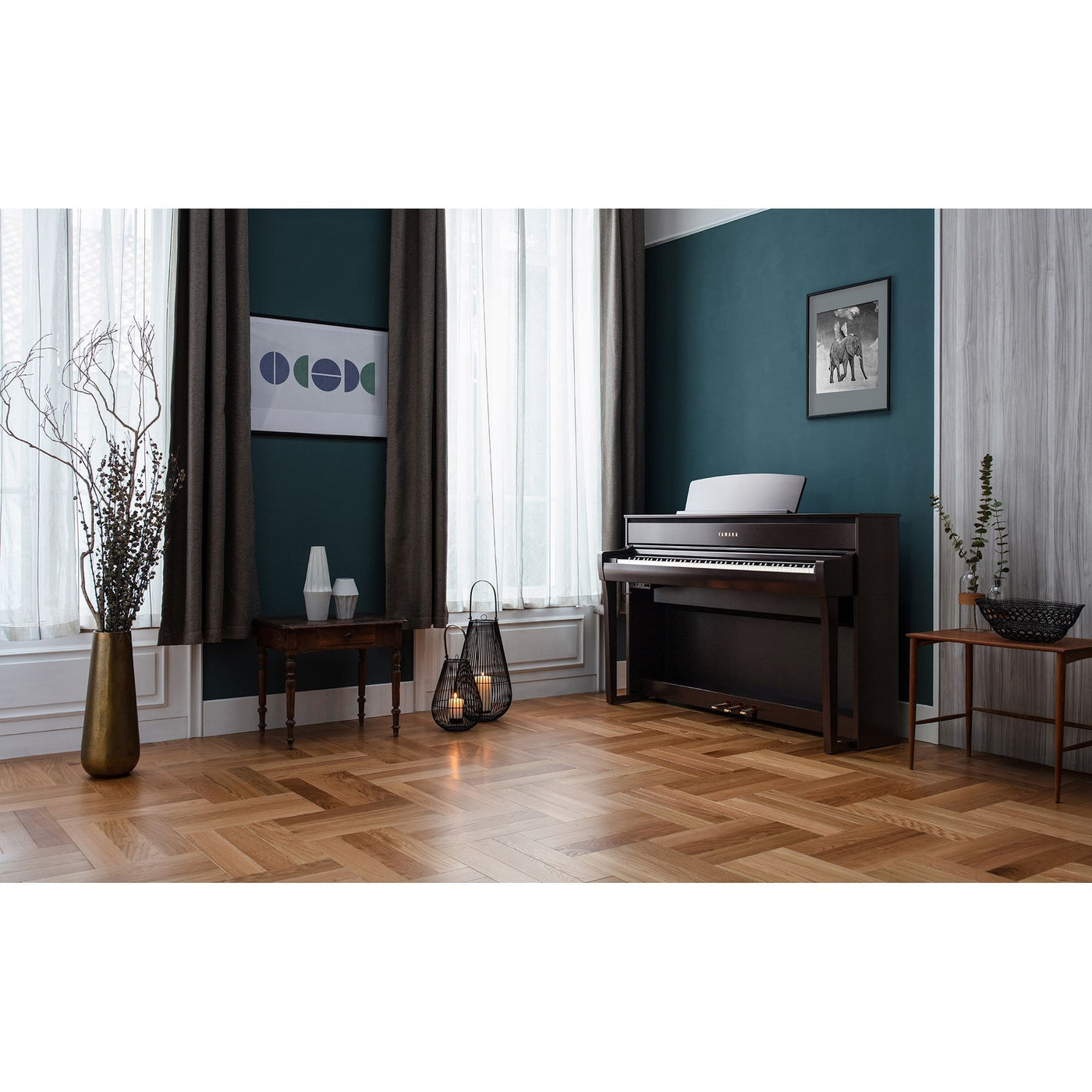 elegant interior room with a black piano, decorative elements, and furniture against a teal wall with long drapes on windows.