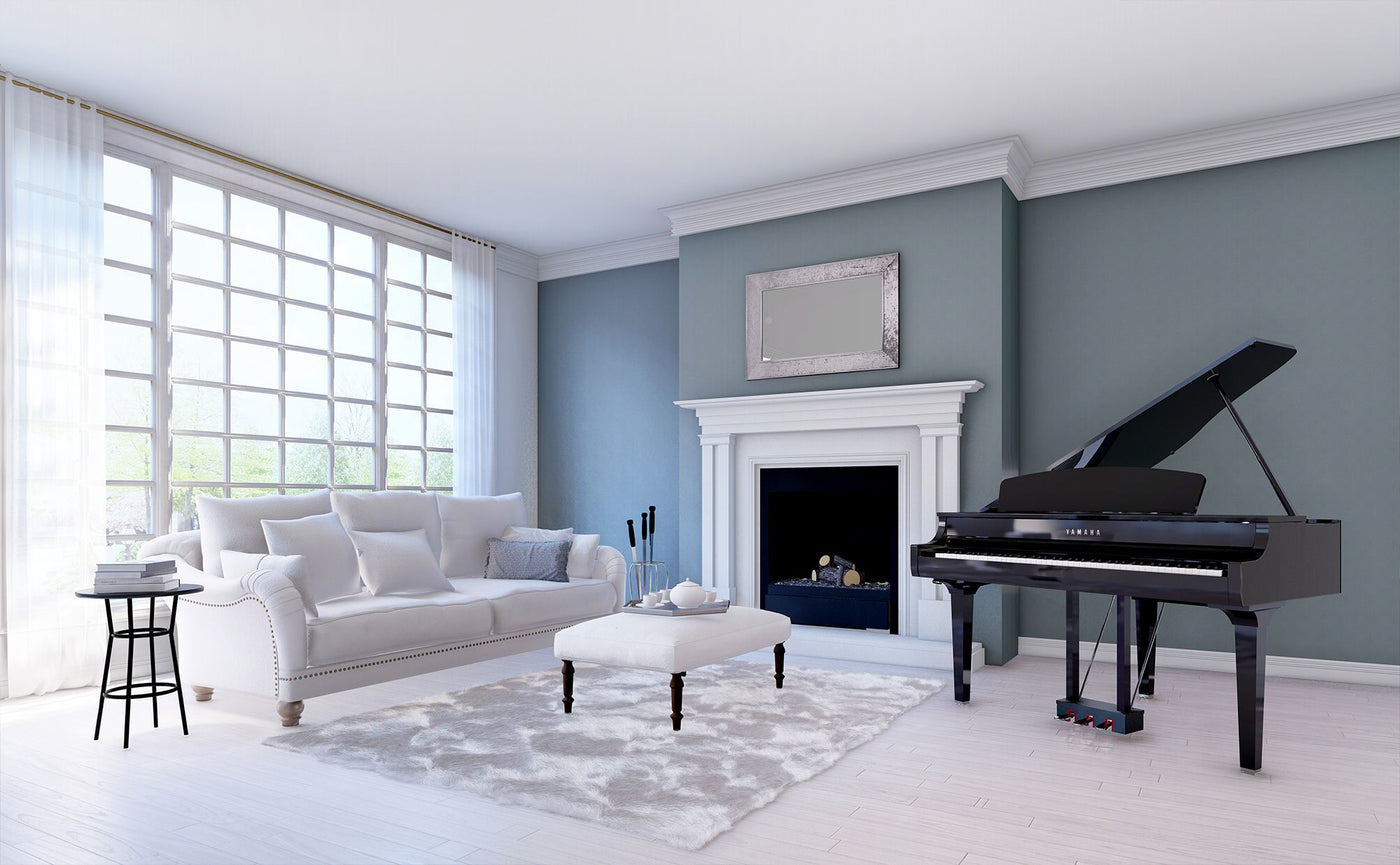Elegant living room with a grand piano beside a fireplace, showcasing a luxurious interior ideal for piano recitals and music enjoyment.