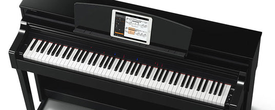 Black digital piano with integrated sheet music display and red and blue lights above certain keys.