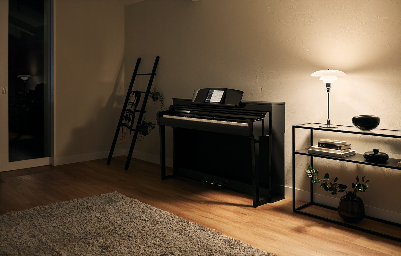 A modern digital piano positioned in a cozy living room setting, with a music stand displaying sheet music, indicating a space designed for piano practice and performance.
