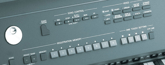 Close-up of electronic keyboard controls with labeled buttons for song control, voice selection, and one touch setting.