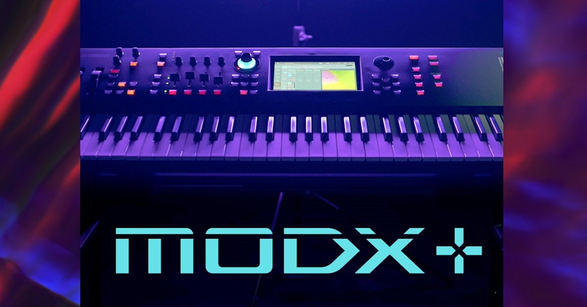 electronic music synthesizer with a screen and various control knobs illuminated in blue and red lights showing the text "modx" on the lower part.
