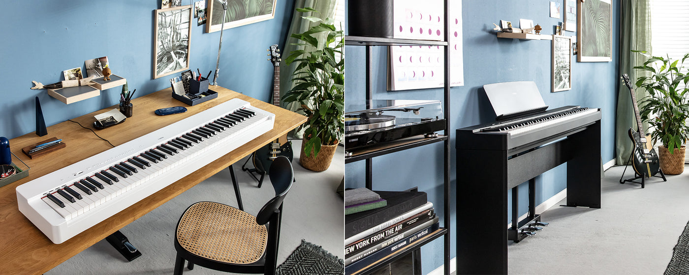 A modern home studio setting with two different digital pianos, one white and one black, on simple desks, surrounded by plants, guitars, and music-related decorations.