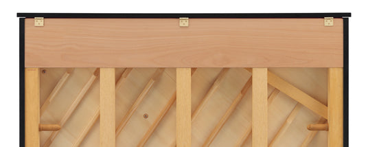Close-up of a wooden piano lid with visible brass hinges and a part of the piano's inner frame and soundboard structure.
