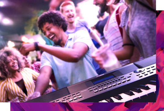 People enjoying a live music event with a focus on a digital keyboard piano in the foreground.